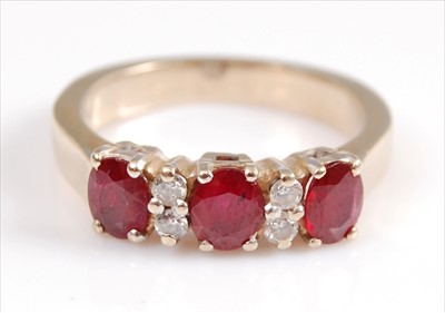 Lot 2066 - A yellow metal, ruby and diamond seven stone...