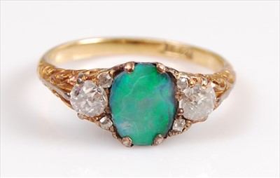 Lot 2067 - A yellow metal carved head black opal triplet...