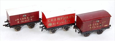 Lot 492 - Three Hornby open axle guard goods vans:-...