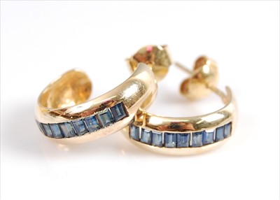 Lot 2071 - A pair of yellow metal sapphire half-hoop...