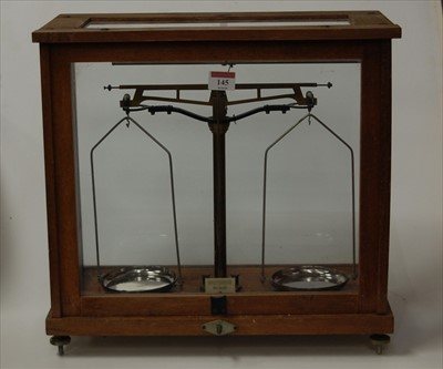 Lot 145 - A cased scientific balance scale, width 42cm
