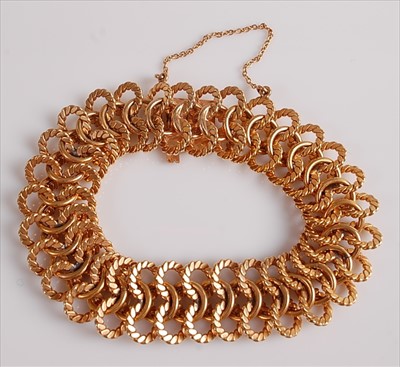 Lot 2132 - A yellow metal fancy three row interlocking...