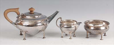 Lot 124 - An early Art Deco silver hammered three-piece...