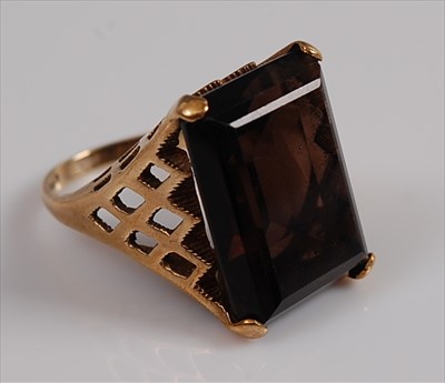 Lot 2144 - A 9ct yellow gold smoky quartz dress ring...