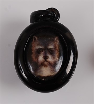 Lot 1206 - An oval jet pendant featuring a centre panel...
