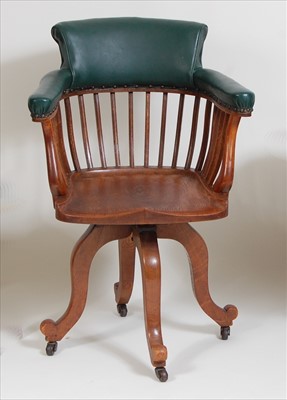 Lot 339 - A 1920s oak and green leather slatback...