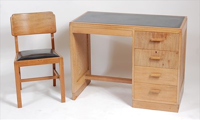 Lot 344 - An Art Deco limed oak single pedestal kneehole...