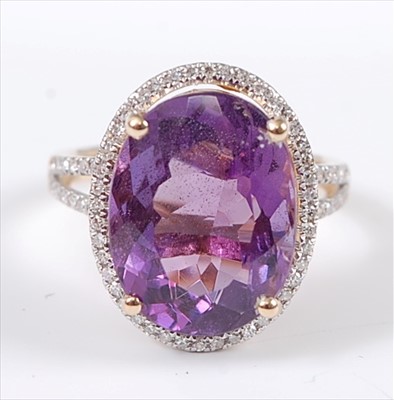 Lot 1227 - A yellow metal, amethyst and diamond oval...