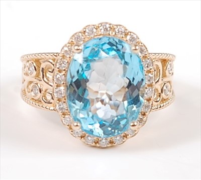 Lot 1228 - A yellow metal, blue topaz and diamond oval...