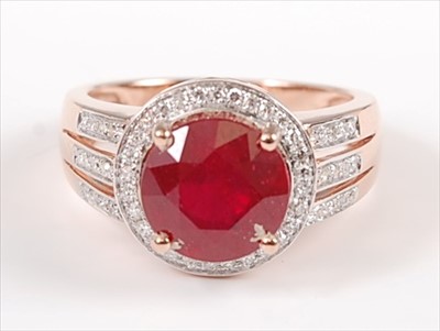 Lot 1229 - A rose gold, ruby and diamond circular cluster...