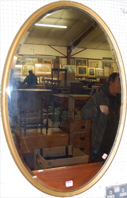Lot 1128 - A reeded gilt decorated bevelled oval wall...
