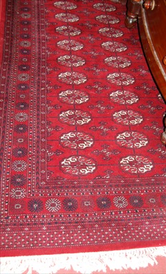 Lot 1142 - A Persian style machine-woven red ground...