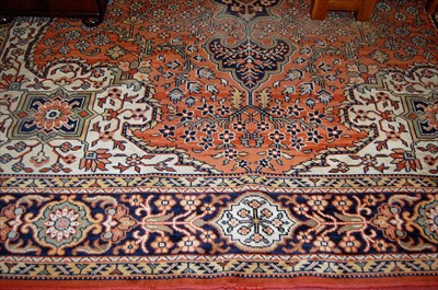 Lot 1143 - A Persian style machine-woven red ground...
