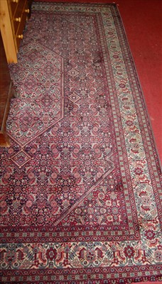 Lot 1145 - A Persian red ground woollen Tabriz rug,...