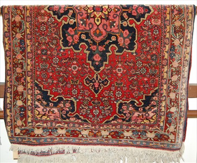 Lot 1148 - A Persian woollen red ground Tabriz rug, 160 x...
