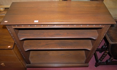 Lot 1185 - A contemporary Ercol mid-elm low freestanding...