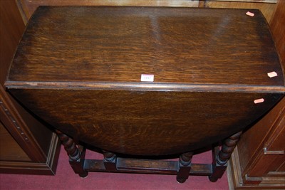 Lot 1187 - A 1920s barleytwist oak dropleaf gateleg...