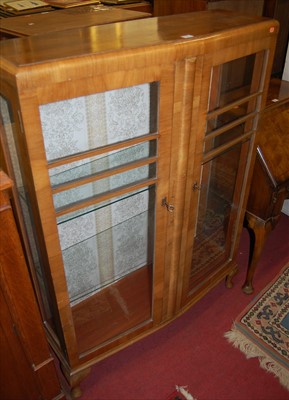 Lot 1190 - An Art Deco figured walnut double door glazed...