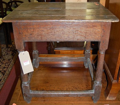 Lot 1197 - An antique joined oak plank-top low occasional...