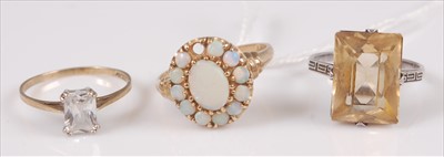 Lot 304 - A 9ct gold and cz set dress ring, size M/N;...