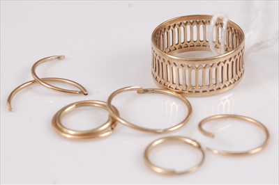 Lot 341 - A yellow metal pierced band ring, unmarked but...