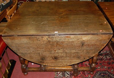 Lot 1248 - A joined oak drop leaf double width dining...