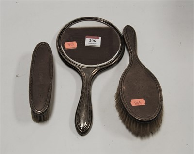Lot 206 - A George V silver backed hand mirror; together...