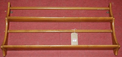 Lot 1295 - An Ercol light elm two-tier wall mounted plate...