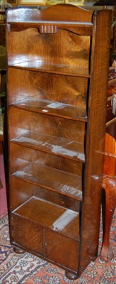 Lot 1297 - A 1930s oak narrow freestanding open bookshelf,...