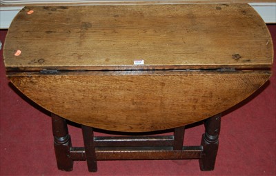 Lot 1344 - An antique joined oak low drop-flap occasional...