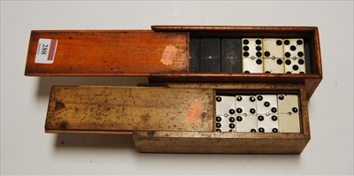 Lot 288 - A set of bone and ebony dominoes in boxwood...