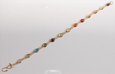 Lot 2163 - A yellow metal multi-stone bracelet, featuring...