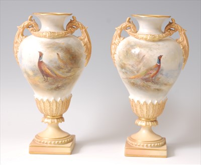 Lot 1074 - A pair of Royal Worcester porcelain pedestal...