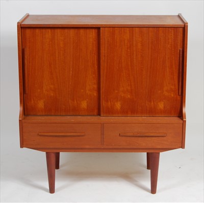 Lot 380 - A 1960s Danish teak side cupboard, having twin...