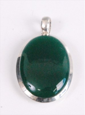 Lot 2081 - A white metal oval moldavite pendant, the...