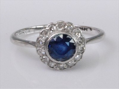 Lot 1219 - A white metal, sapphire and diamond circular...