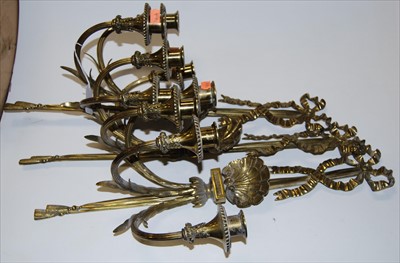 Lot 69 - A set of three brass three-sconce wall light...