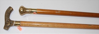Lot 77 - A modern walking cane, having embossed brass...