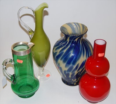 Lot 78 - A George V green tinted glass pitcher, having...