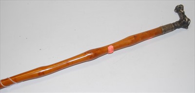 Lot 86 - A circa 1900 walking cane, having a white...