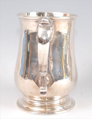 Lot 1157 - A George II silver bell shaped tankard, having...