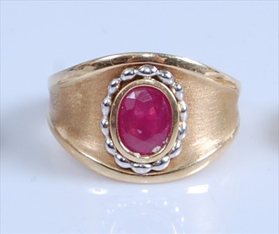Lot 1246 - A yellow metal ruby set heavy dress ring,...