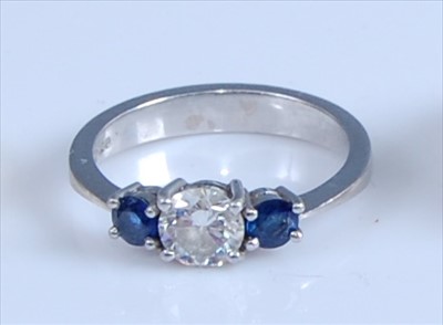 Lot 1245 - A platinum, diamond and sapphire three-stone...