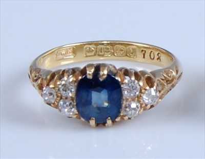 Lot 1239 - An 18ct yellow gold, sapphire and diamond ring,...