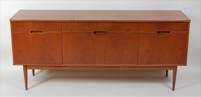 Lot 383 - A 1960s British teak long sideboard, having...
