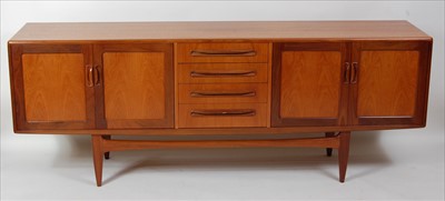 Lot 379 - A 1960s G-Plan teak long sideboard, having...