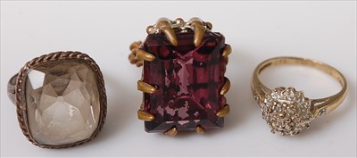Lot 442 - A gilt metal and amethyst set dress ring;...