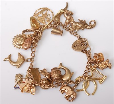 Lot 447 - A modern 9ct gold charm bracelet, set with...
