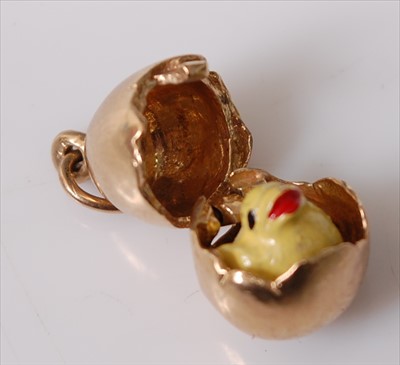 Lot 2207 - A 9ct yellow gold egg charm opening to reveal...