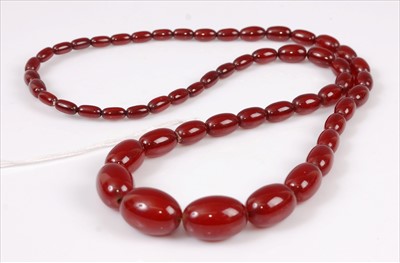 Lot 2168 - A single row necklace of 54 graduated oval...